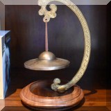 D28. Brass bell décor. 